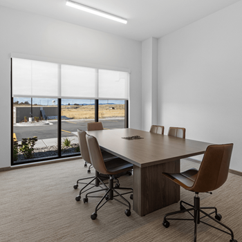 a conference room with a table and chairs and a window at Yellowstone Landing, Montana